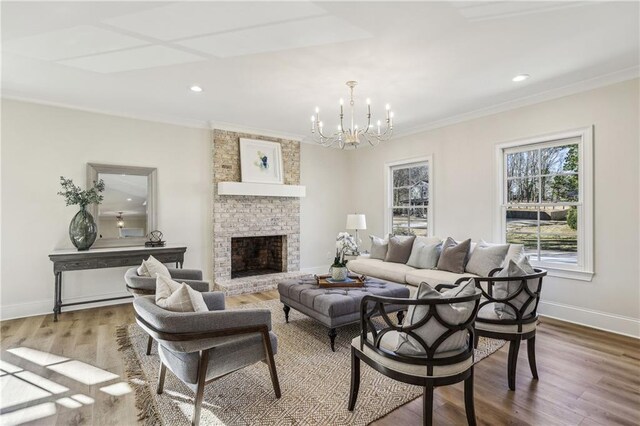 living room featuring a notable chandelier, crown molding, baseboards, and wood finished floors