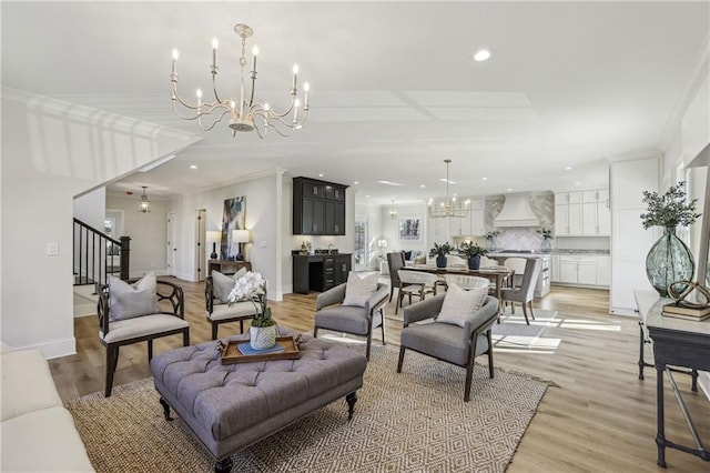 living room featuring stairs, recessed lighting, light wood-style floors, and a chandelier