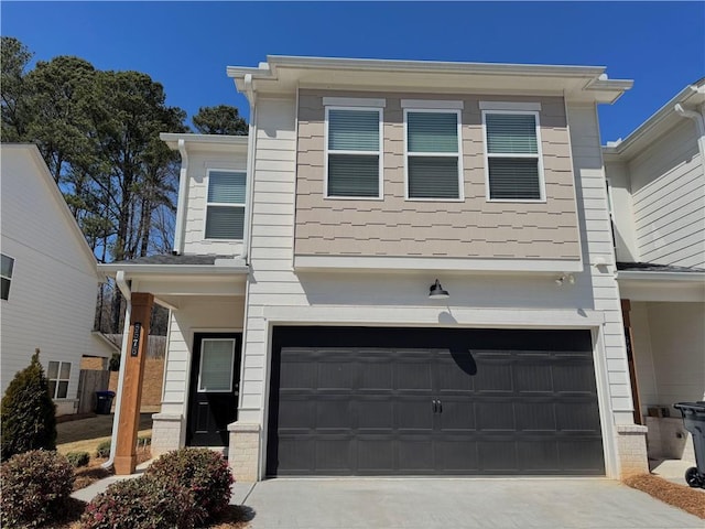 view of front of property featuring concrete driveway and an attached garage