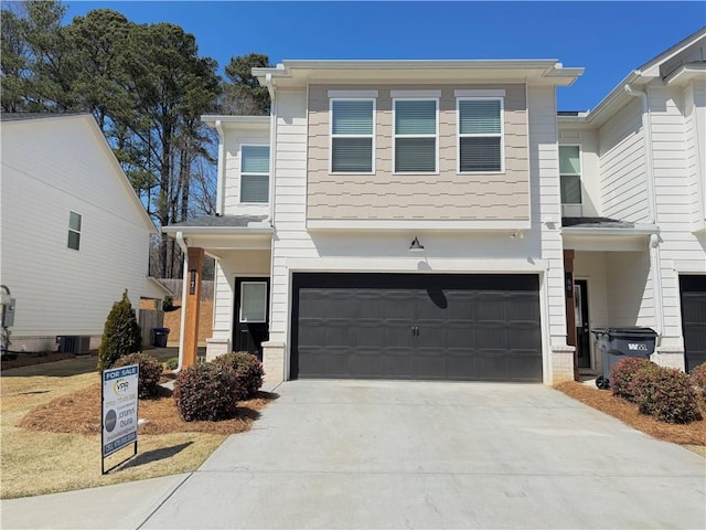 view of front of property featuring brick siding, central AC unit, an attached garage, and concrete driveway