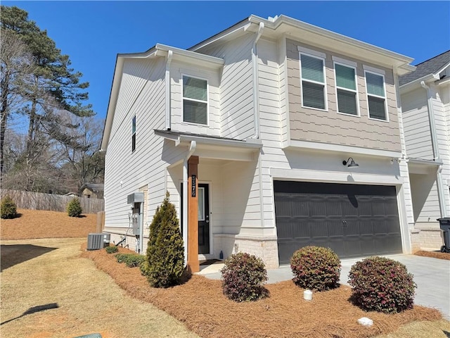 view of front of property featuring cooling unit, fence, a garage, and driveway