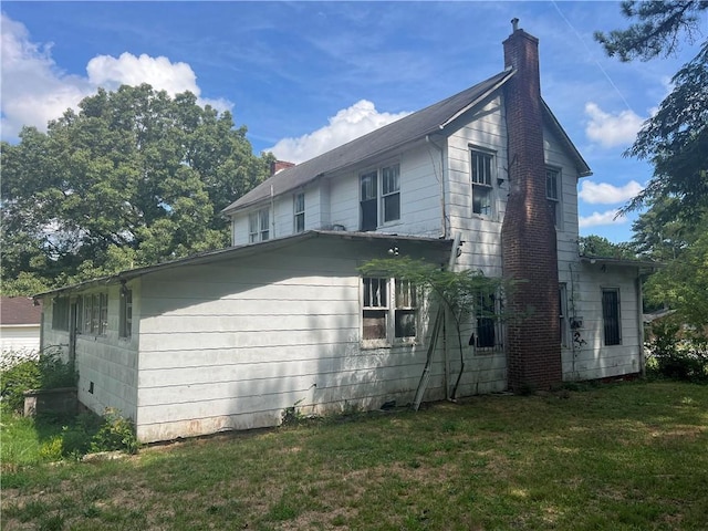 view of side of home with a lawn