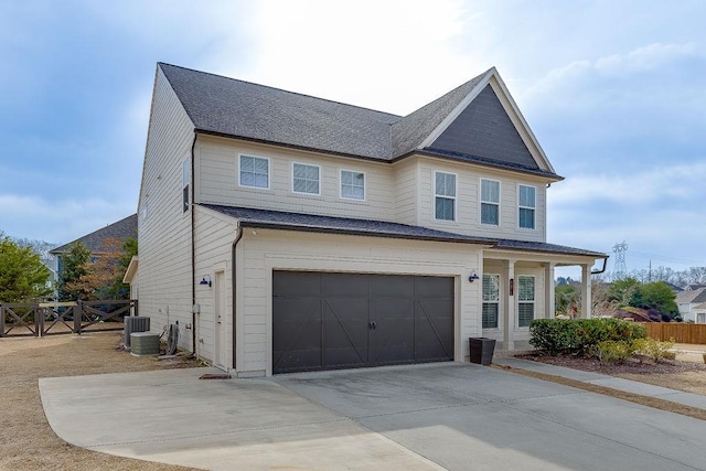 view of front of property featuring driveway, fence, cooling unit, an attached garage, and a shingled roof