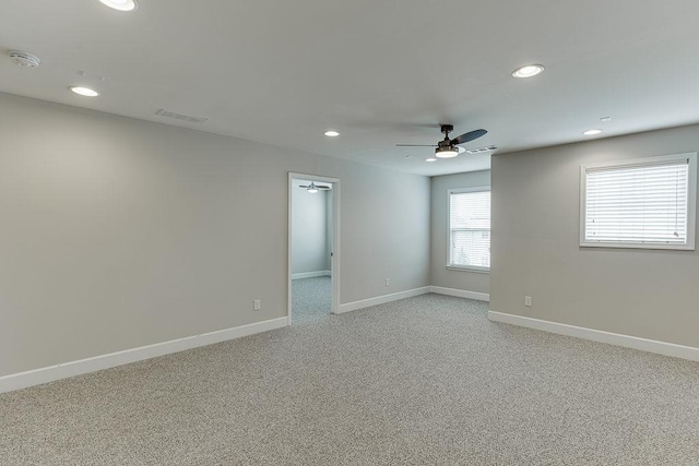 spare room with visible vents, baseboards, light colored carpet, recessed lighting, and a ceiling fan