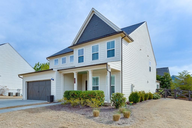 view of front of home featuring an attached garage, fence, central air condition unit, driveway, and a gate