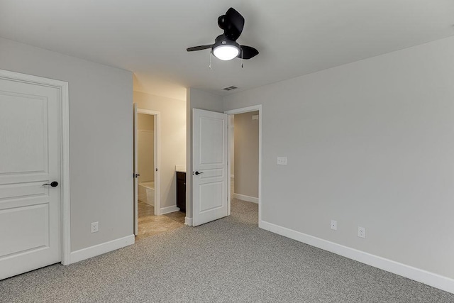 unfurnished bedroom with visible vents, baseboards, light carpet, and a ceiling fan