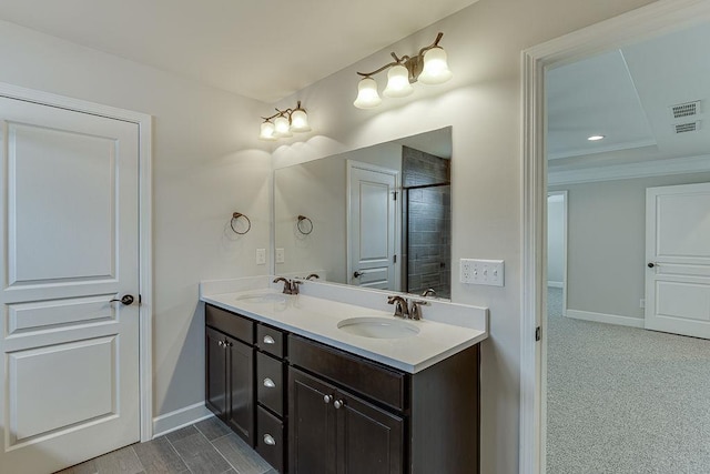 bathroom featuring a sink, baseboards, and double vanity