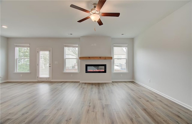 unfurnished living room with ceiling fan and light hardwood / wood-style floors