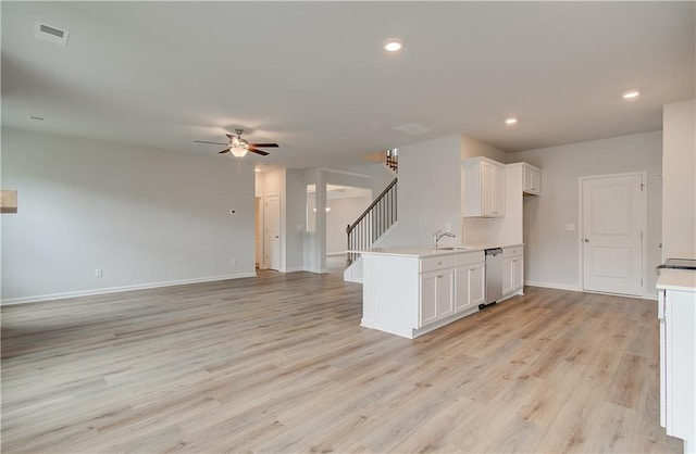 kitchen featuring white cabinetry, light wood-type flooring, ceiling fan, sink, and dishwasher