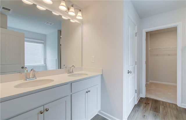 bathroom featuring double vanity and hardwood / wood-style flooring