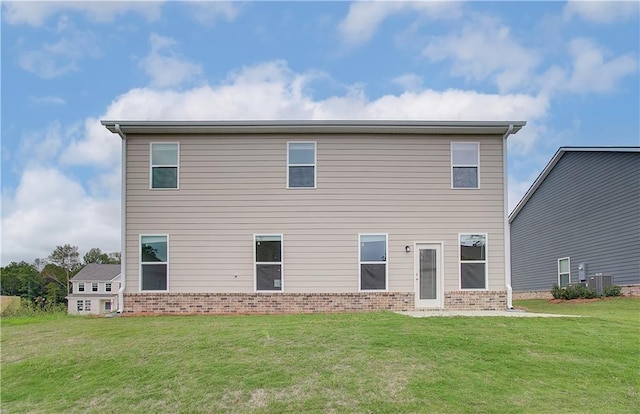 rear view of house featuring a lawn