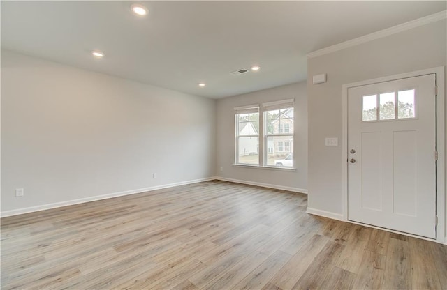 foyer entrance with a wealth of natural light and light wood-type flooring