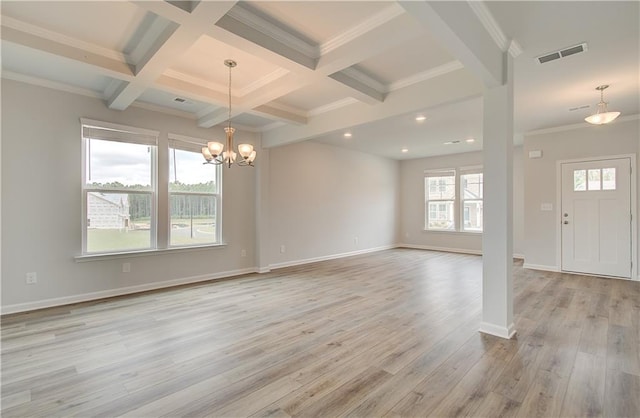 entryway with beam ceiling, light hardwood / wood-style floors, coffered ceiling, and an inviting chandelier