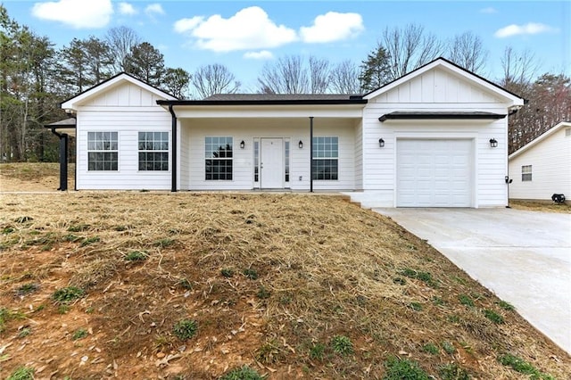 ranch-style home featuring a garage, driveway, and board and batten siding