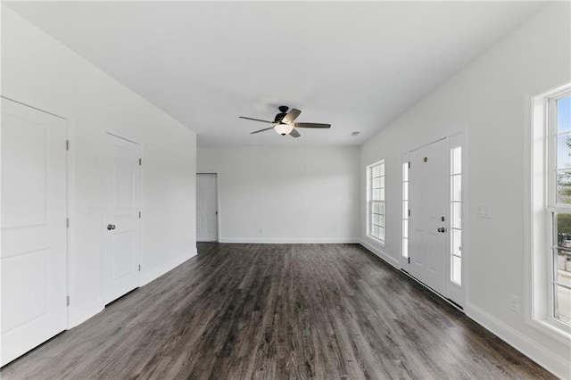 entrance foyer with a ceiling fan, dark wood finished floors, and baseboards