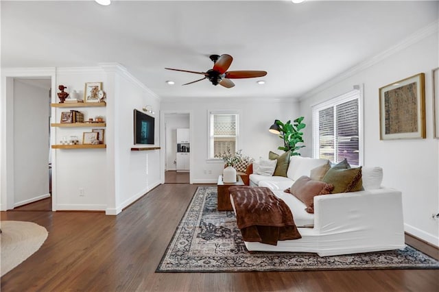 living room featuring ceiling fan, ornamental molding, and a wealth of natural light