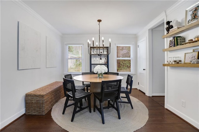 dining area with dark wood-type flooring, crown molding, and a chandelier