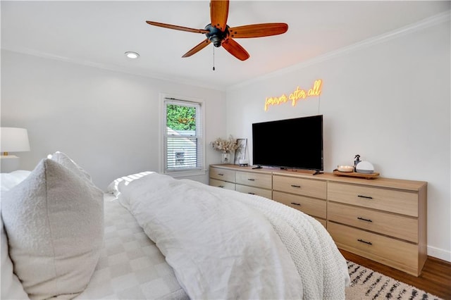 bedroom featuring ceiling fan, light hardwood / wood-style floors, and ornamental molding