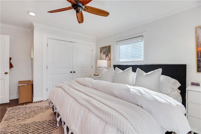 bedroom with ceiling fan, hardwood / wood-style floors, a closet, and crown molding