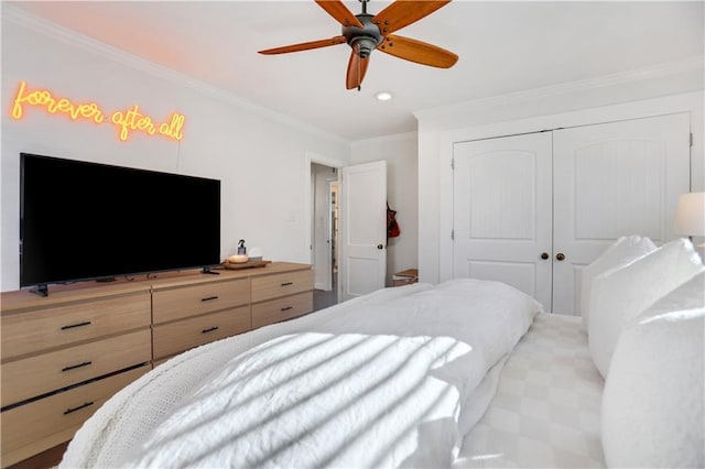 bedroom featuring ceiling fan, a closet, and crown molding