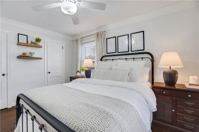 bedroom featuring dark hardwood / wood-style flooring, ceiling fan, and ornamental molding