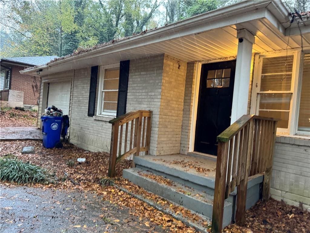 doorway to property with a garage