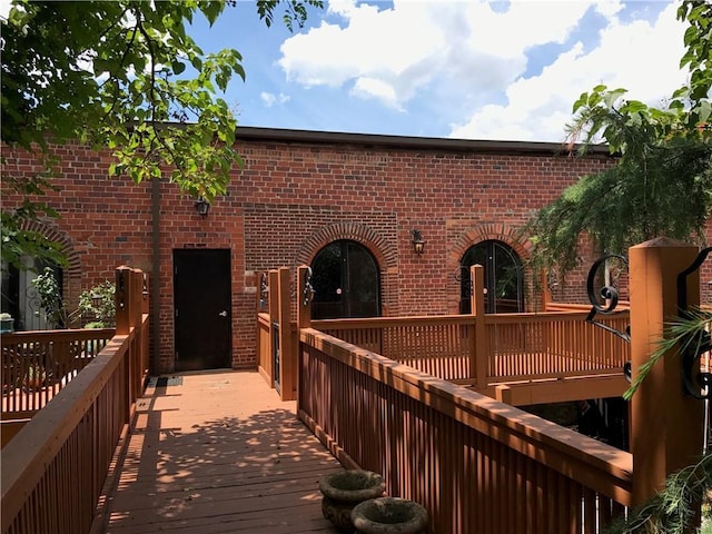 rear view of property with brick siding