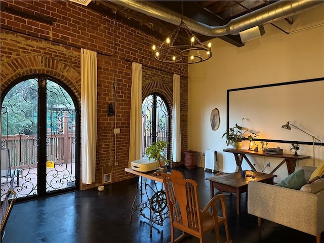 dining space with french doors, arched walkways, and brick wall