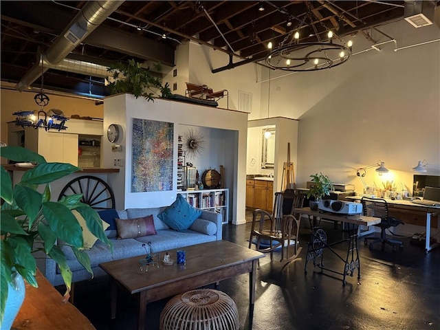 living room featuring a notable chandelier and a high ceiling