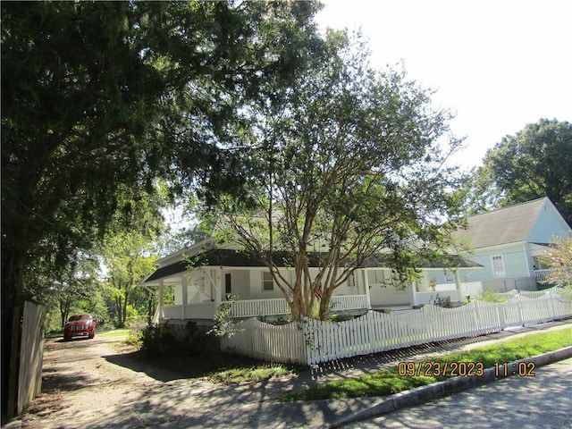 view of side of home with covered porch