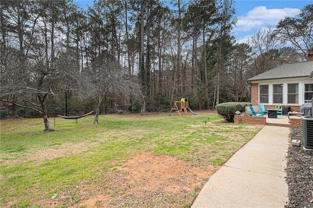 view of yard featuring a playground and a patio