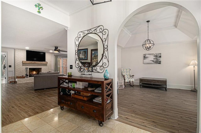 corridor with crown molding, baseboards, and wood finished floors