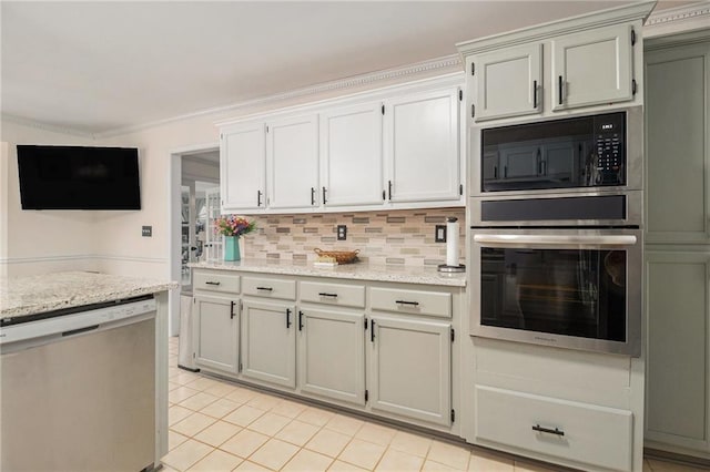 kitchen with light tile patterned floors, light stone counters, stainless steel appliances, ornamental molding, and decorative backsplash