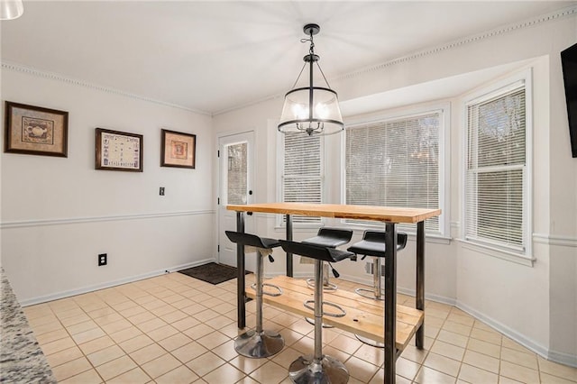 dining space featuring light tile patterned flooring, an inviting chandelier, and baseboards