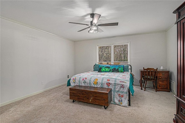 carpeted bedroom featuring ornamental molding, baseboards, and a ceiling fan