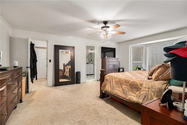 bedroom with a ceiling fan, a walk in closet, light carpet, and crown molding