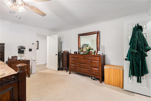 carpeted bedroom featuring ceiling fan and ornamental molding