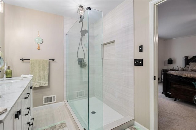 bathroom featuring a stall shower, visible vents, and vanity