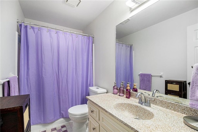 bathroom featuring toilet, curtained shower, and vanity