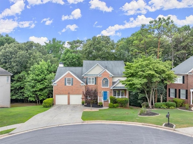 view of front of house featuring a garage and a front yard