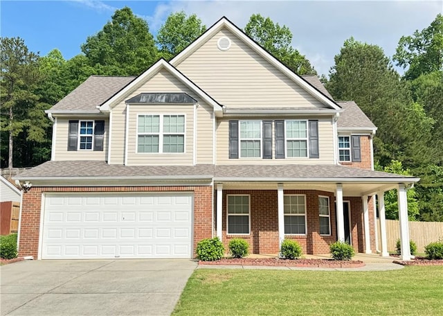 5421 Skylar Creek Ln, Buford, GA 30518 - view of front facade with driveway, brick siding, an attached garage, and a porch