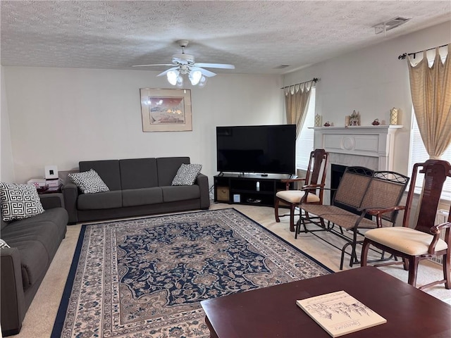5421 Skylar Creek Ln, Buford, GA 30518 - living room with light colored carpet, ceiling fan, a textured ceiling, and a tiled fireplace