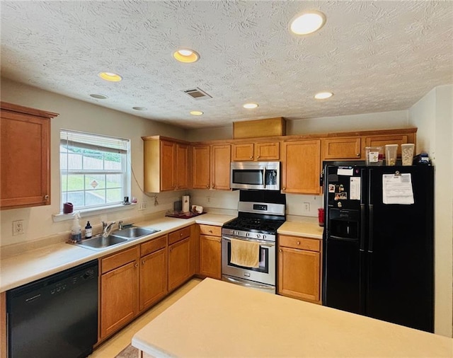 5421 Skylar Creek Ln, Buford, GA 30518 - kitchen with black appliances, light countertops, brown cabinets, a textured ceiling, and recessed lighting