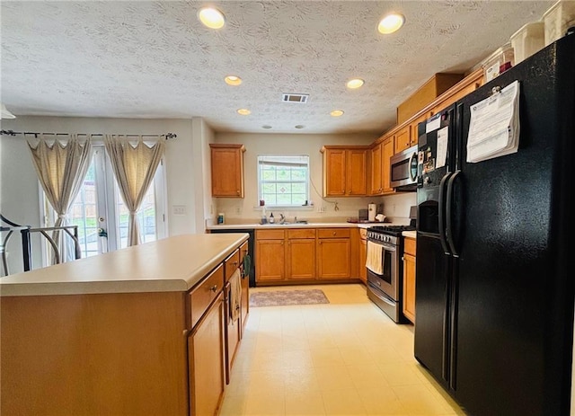 5421 Skylar Creek Ln, Buford, GA 30518 - kitchen with appliances with stainless steel finishes, brown cabinetry, light countertops, light flooring, and recessed lighting