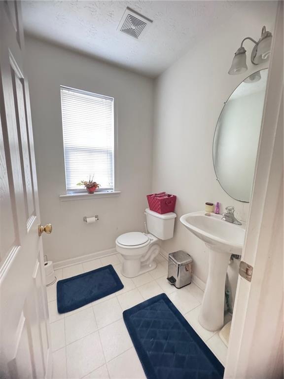 5421 Skylar Creek Ln, Buford, GA 30518 - bathroom featuring tile patterned floors and a textured ceiling