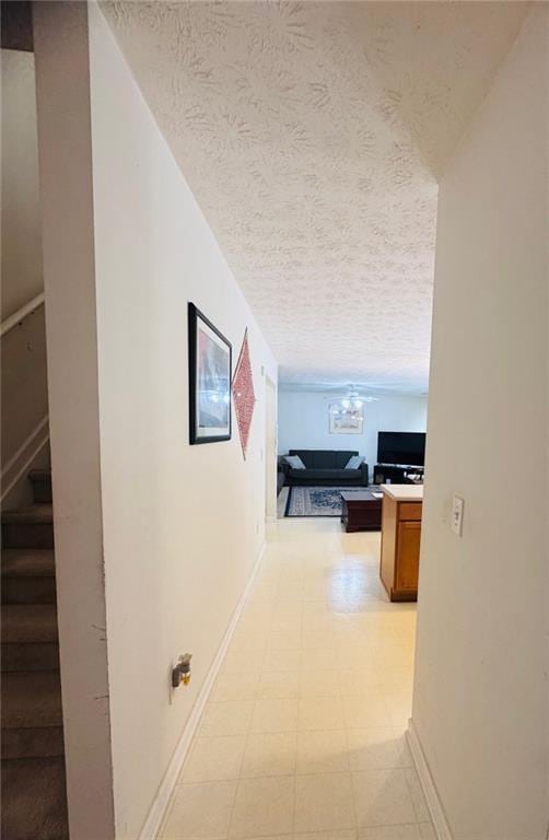 5421 Skylar Creek Ln, Buford, GA 30518 - hall featuring a textured ceiling, light flooring, and stairway