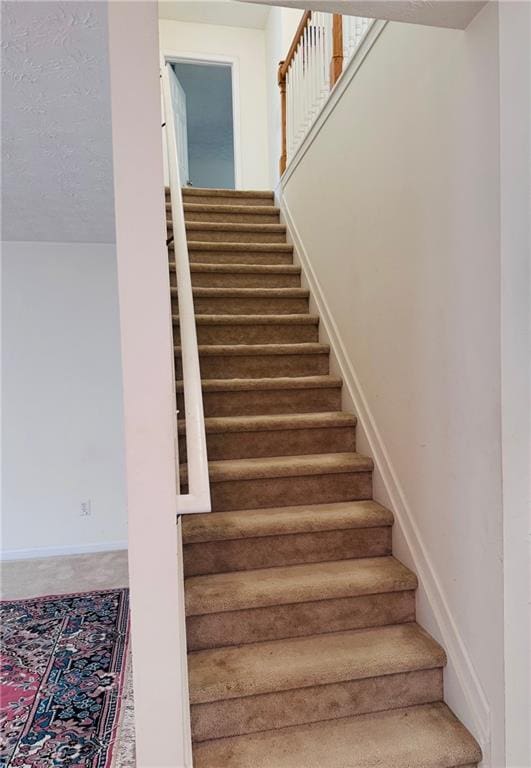 5421 Skylar Creek Ln, Buford, GA 30518 - stairway featuring carpet floors and baseboards