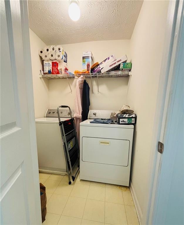 5421 Skylar Creek Ln, Buford, GA 30518 - laundry area with a textured ceiling, light tile patterned floors, and separate washer and dryer