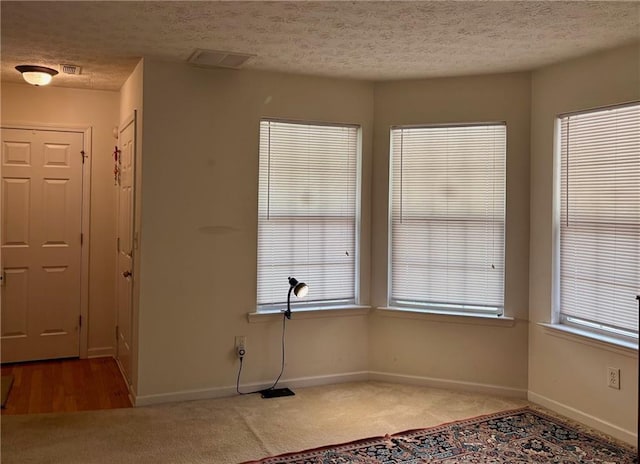 5421 Skylar Creek Ln, Buford, GA 30518 - unfurnished dining area with a textured ceiling, carpet floors, and plenty of natural light