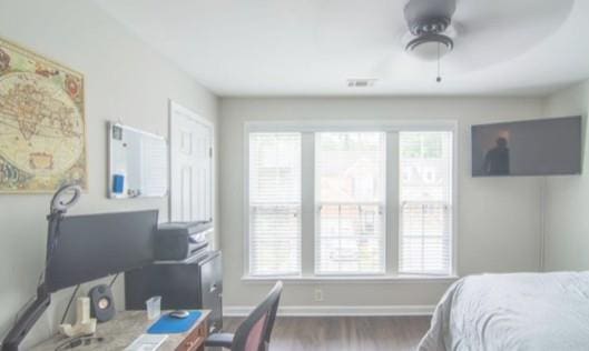 bedroom with dark hardwood / wood-style floors